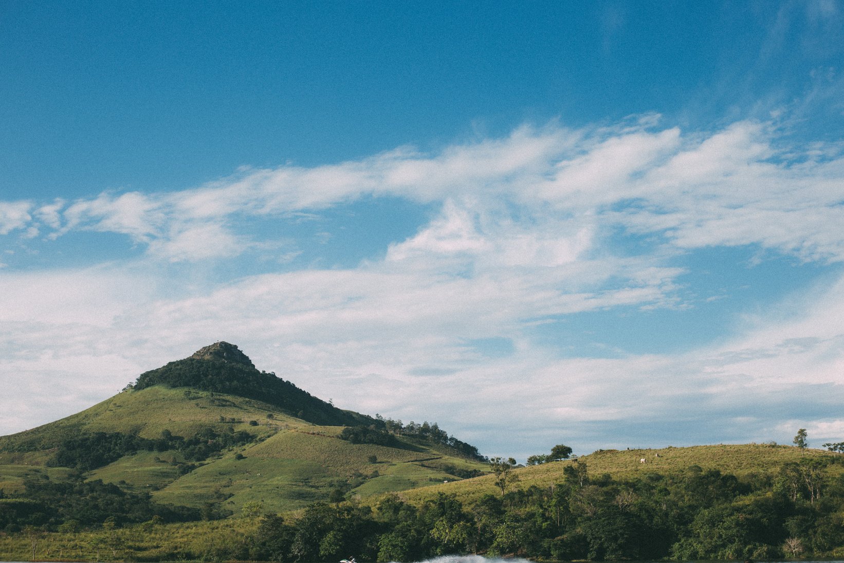 Green Grass Covered Mountain Under Blue Sky